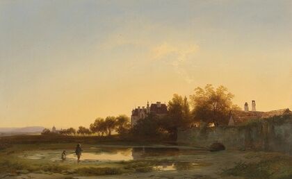 Angler in the evening light by the castle pond