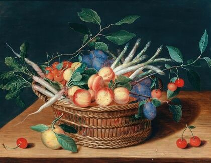 Apricots, cherries, plums, radishes and asparagus in a wicker basket