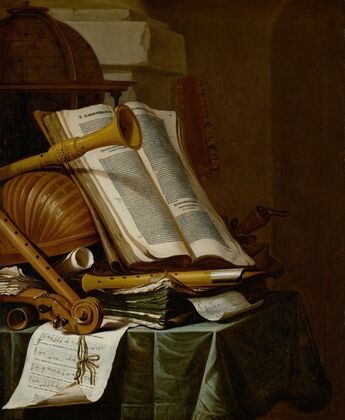 Books, a globe and musical instruments on a draped table