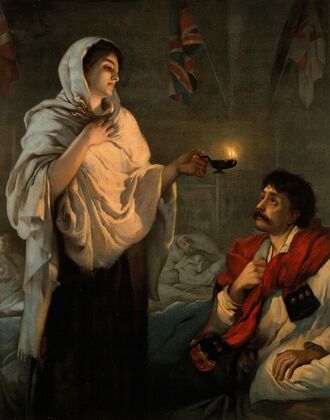 Florence Nightingale with her lamp at a patient’s bedside.
