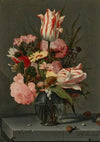Flowers in a glass vase on a ledge