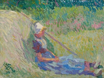 Girl resting against a haystack
