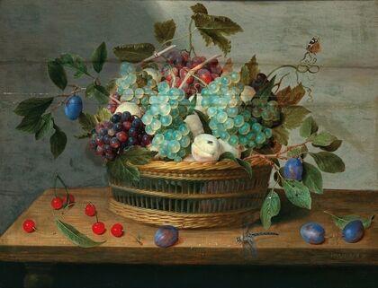 Grapes, peaches, plums and cherries in a wicker basket with dragonfly and butterfly nearby