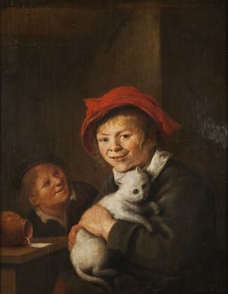 Two boys playing with a cat
