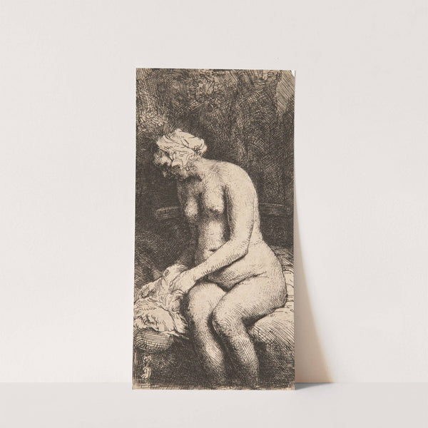 Woman bathing her feet at a brook by Rembrandt van Rijn