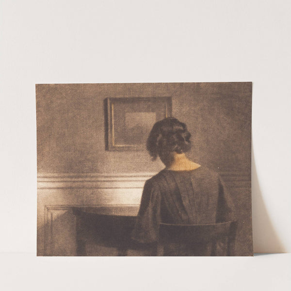 Young girl by a semi-circular table by Peter Ilsted