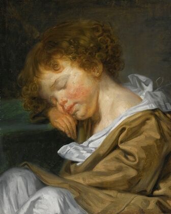 A Boy Asleep On A Table