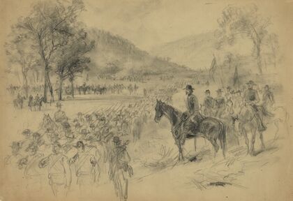 A general and his staff reviewing troops in the field
