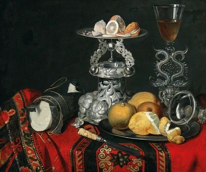 A still life with a Venetian glass, a silver vessel and lemons