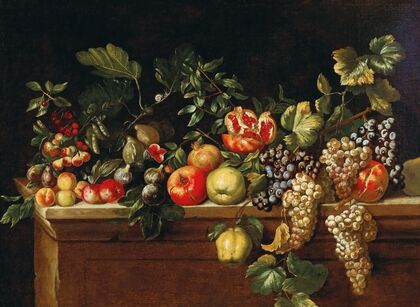 Apples, grapes, figs and pomegranates and other fruit on a ledge