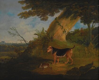 Black and tan terrier with a retrieved rabbit