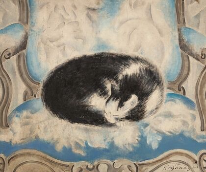 Cat sleeping on an armchair