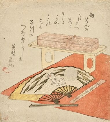 Fan painting of rabbit and moon, on a red felt blanket