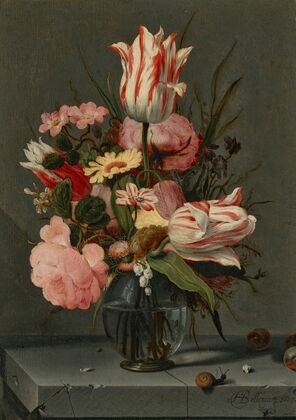 Flowers in a glass vase on a ledge