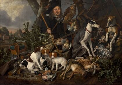 Gentleman hunter with his pack of dogs and his hunting trophies — size preview