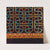 Geometric maze-like patterns in brown, blue, green, and yellow on black ground (late 19th century)