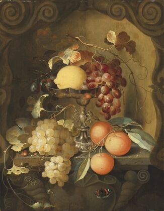 Grapes and a lemon on a tazza, with oranges on a ledge in a sculpted stone niche