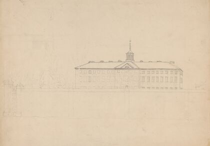 Large building with a cupola behind a high wall