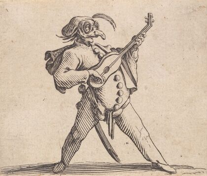 Le comédien masqué, avec lunettes, et jouant de la guitare