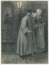 Man and woman walking the street at night