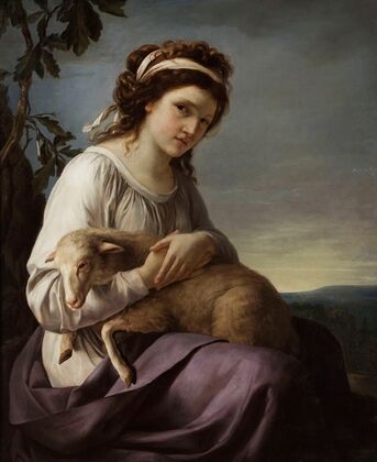 Portrait of a young woman holding a lamb
