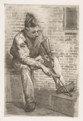 Soldier cleaning his rifle