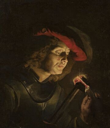 Soldier lighting a candle