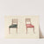 Two chairs with red, black cushions by Thomas Sheraton