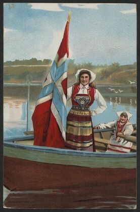 Two women dressed in traditional Norwegian costumes with flags in a boat