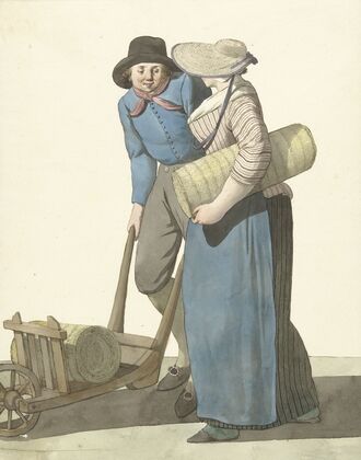 Vrouw naast een man met een kruiwagen